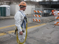 Worker wearing personal air monitor for lead exposure in preparation of Railroad and Highway Bridge modifications 2015
